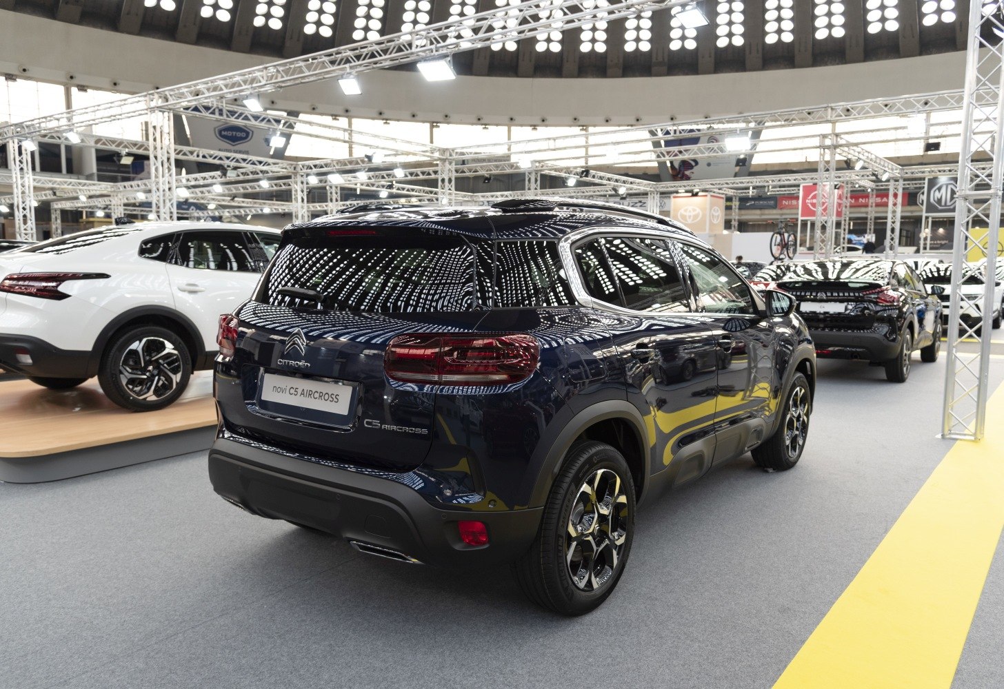 Rear view and alloy wheels of modern SUV at auto show