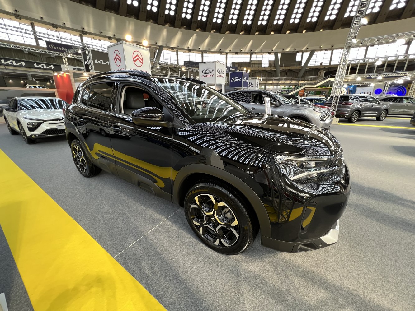 Black SUV front-side view with alloy wheels and sleek headlights