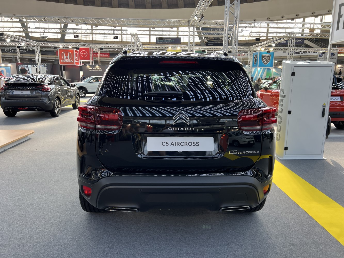 Rear view of modern SUV with updated taillights and sleek rear bumper.