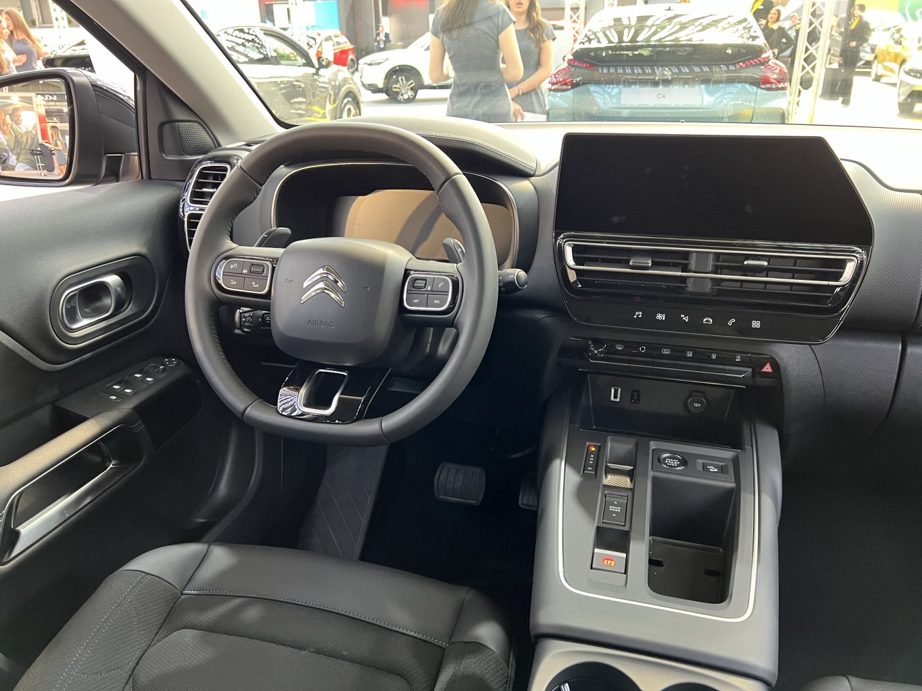 Steering wheel with control buttons and large touchscreen infotainment system.