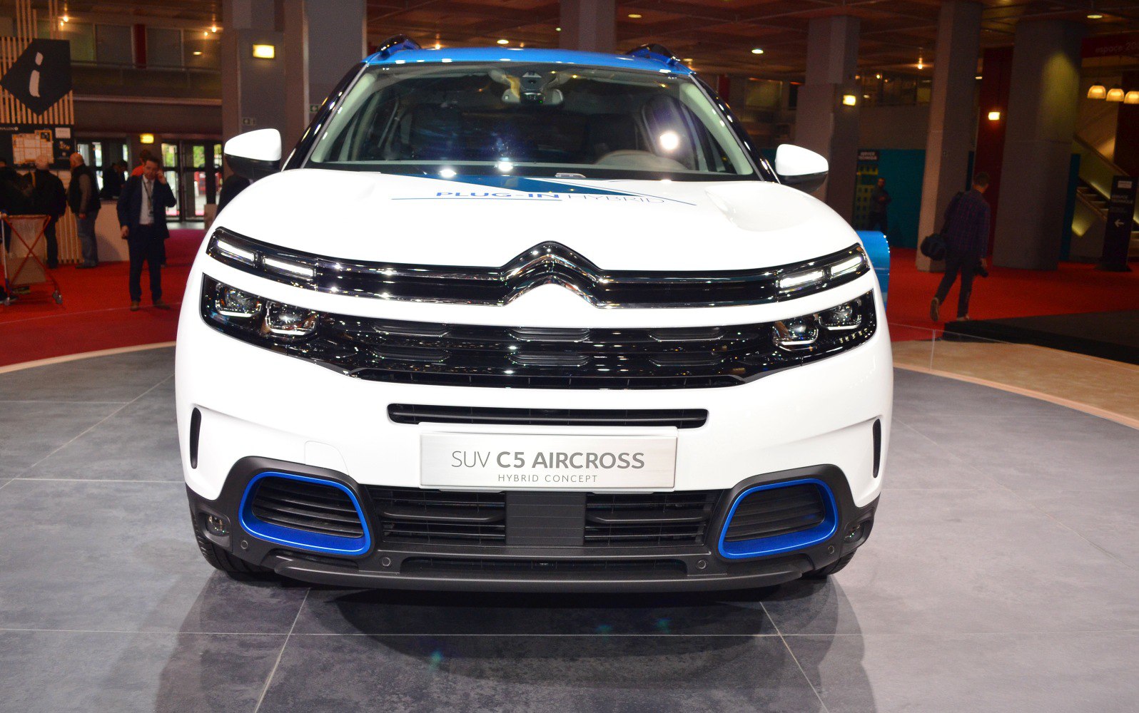 Front grille with chrome chevron and LED headlights on white SUV