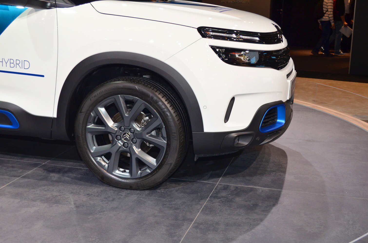 Front section with headlights and detailed alloy wheel with blue accents