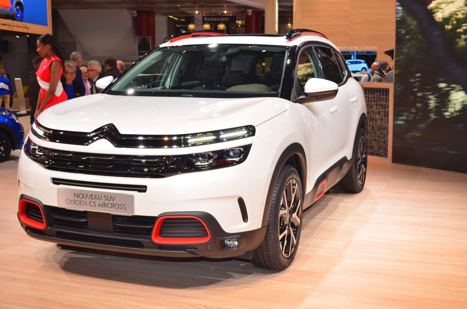 White SUV front with LED headlights and red accent trims