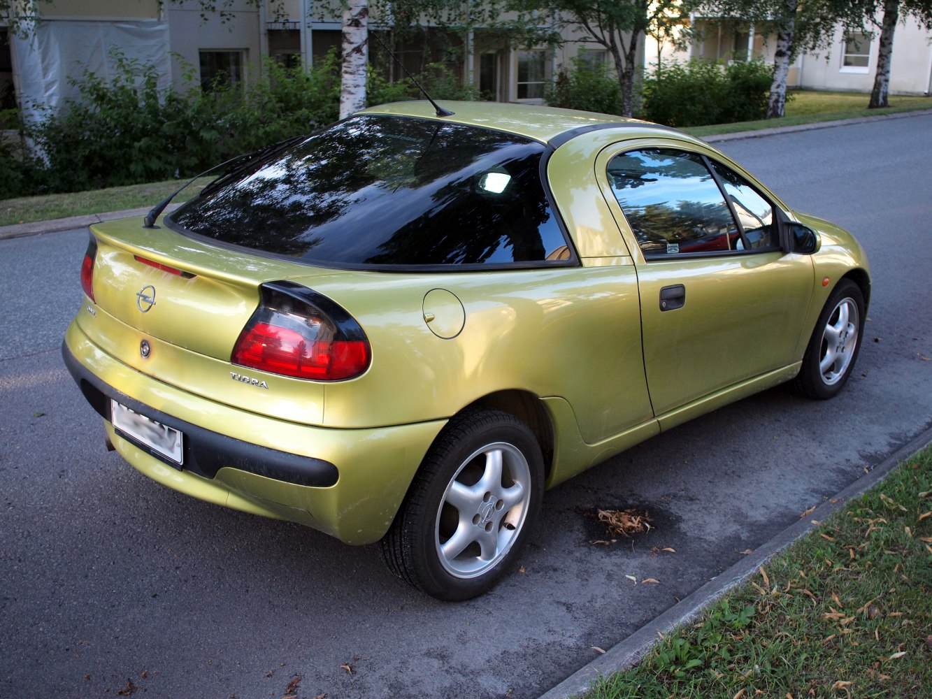 Rear side of a compact hatchback with tinted windows and alloy wheels