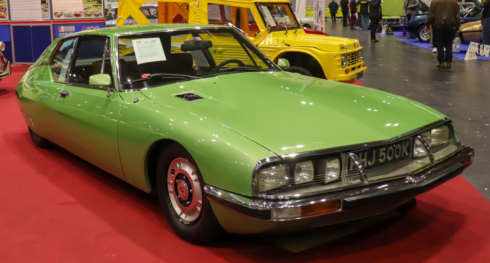 Vintage green luxury sports coupe with aerodynamic body and distinctive front view