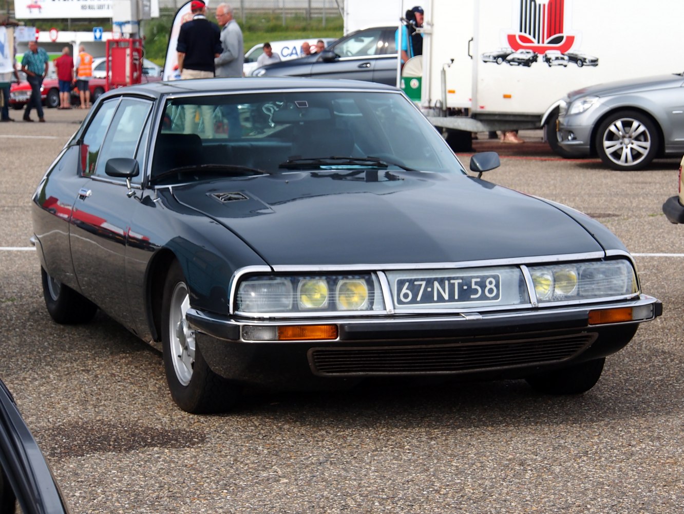 Aerodynamic vintage coupe with quad headlights and distinct grille.