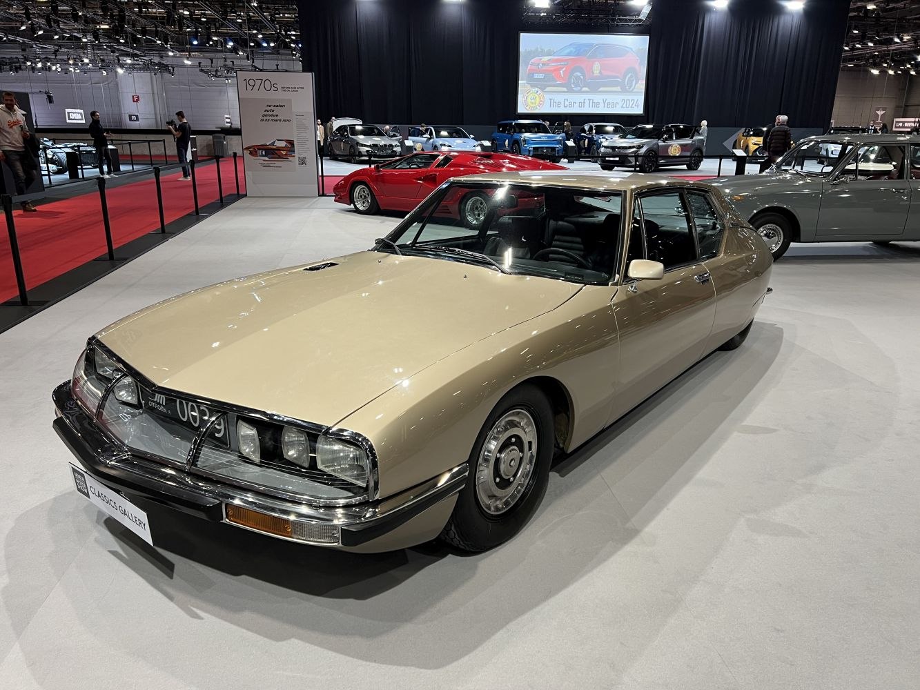 Vintage luxury sedan with quad-headlight front and smooth flowing body lines