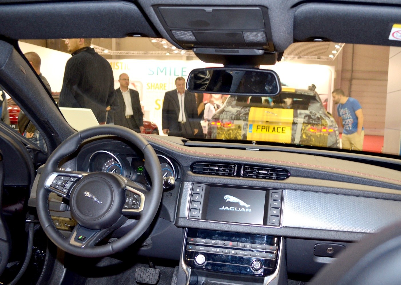 Steering wheel and dashboard with central infotainment screen and controls