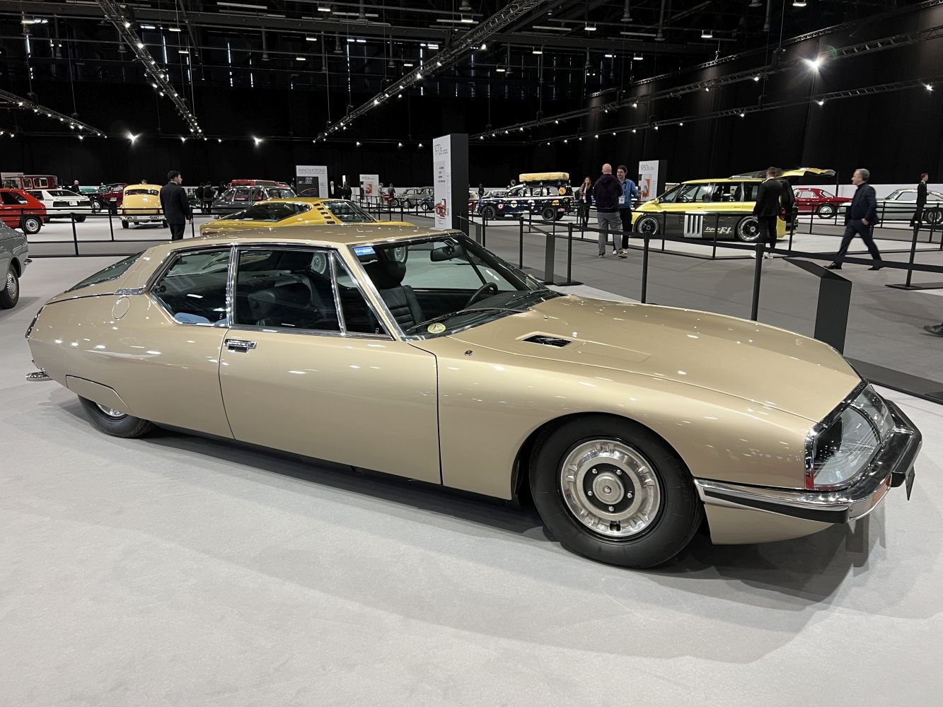 Sleek aerodynamic luxury coupe with distinctive headlight covers.