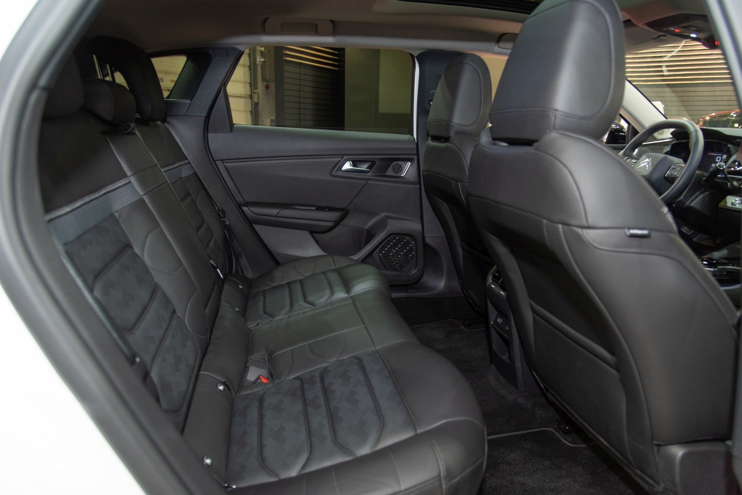 Black leather rear seats with door panel in modern car interior
