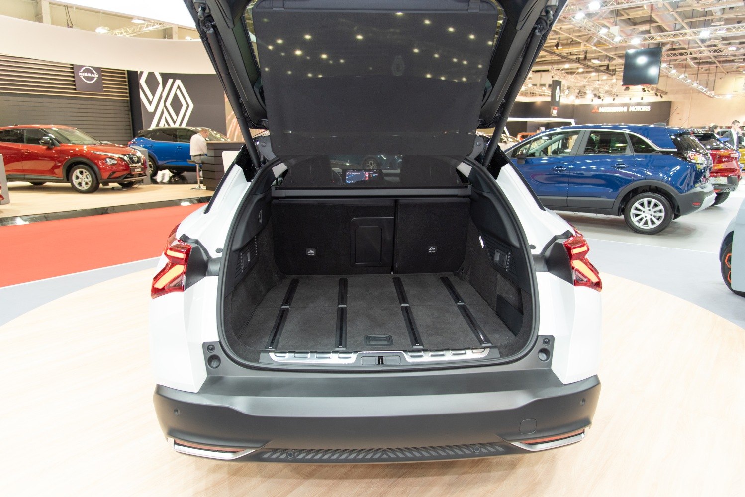 Spacious open trunk interior with cargo rails and foldable rear seats