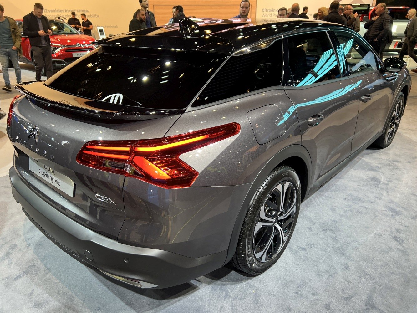 Rear and side view of car with distinctive taillights and sleek black roof