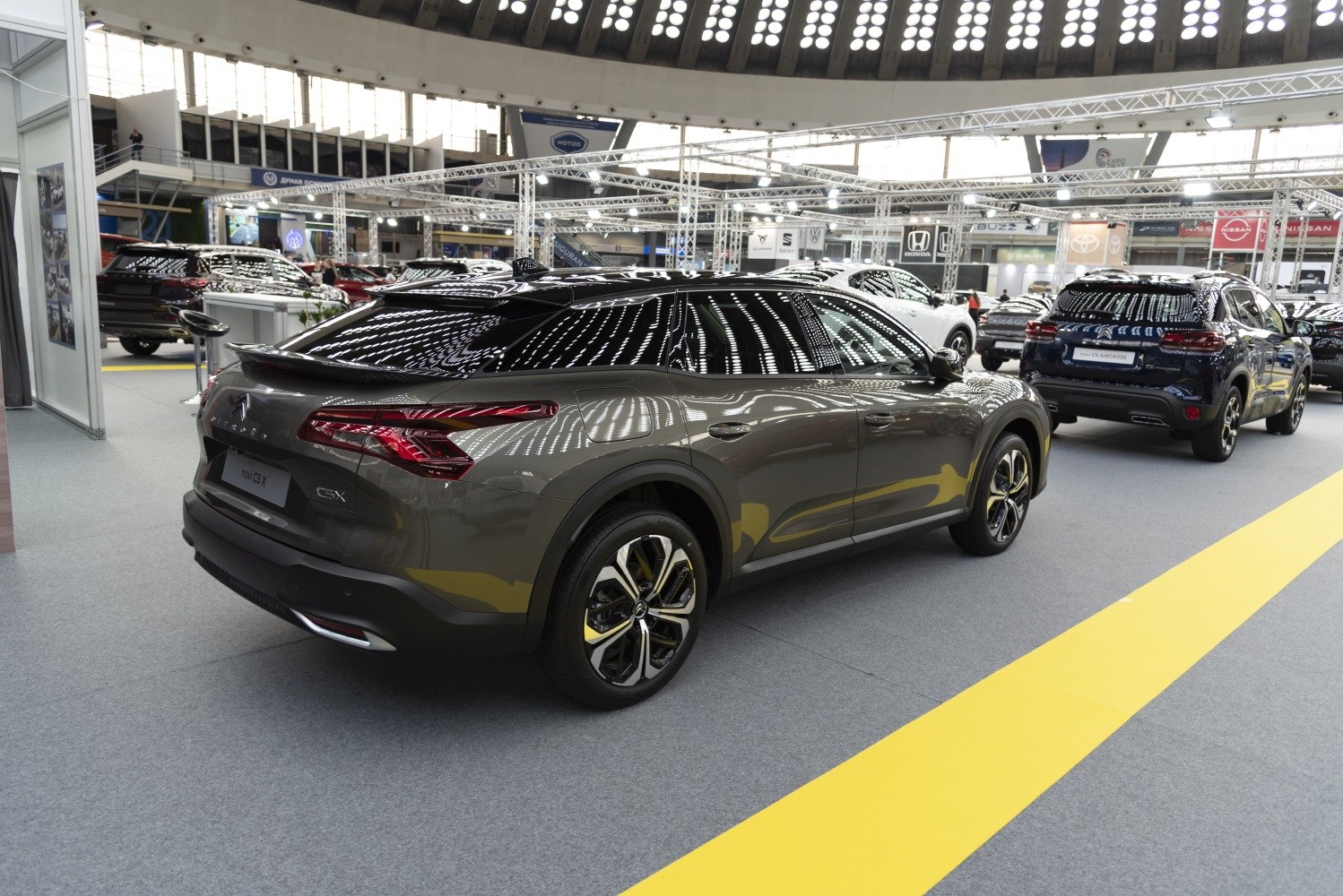 Rear and side profile of a 2022 modern SUV with glossy finish and detailed lighting reflections