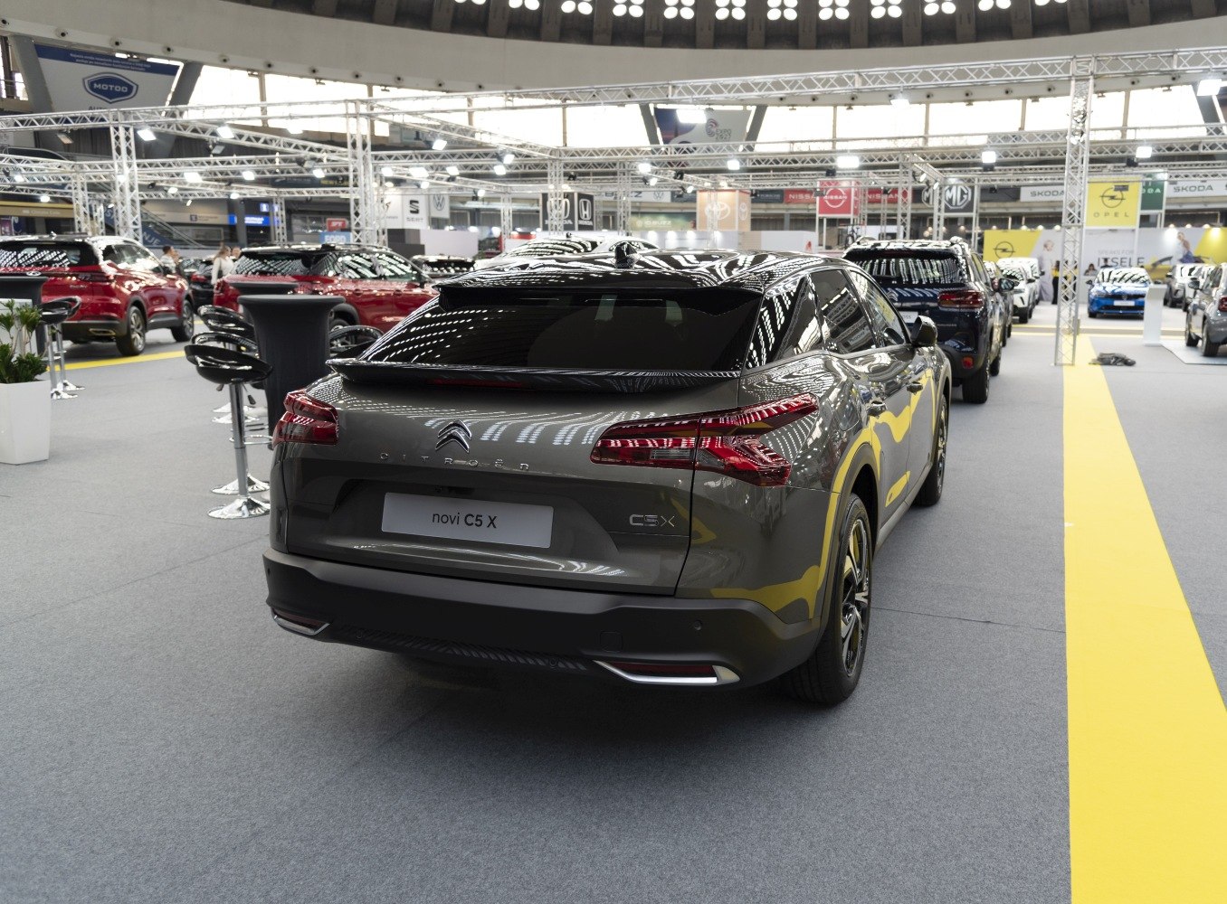 Rear view of modern grey mid-size SUV with distinctive tail lights