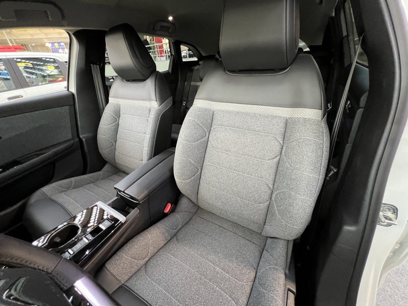 Front seats with fabric and leather upholstery alongside center console controls