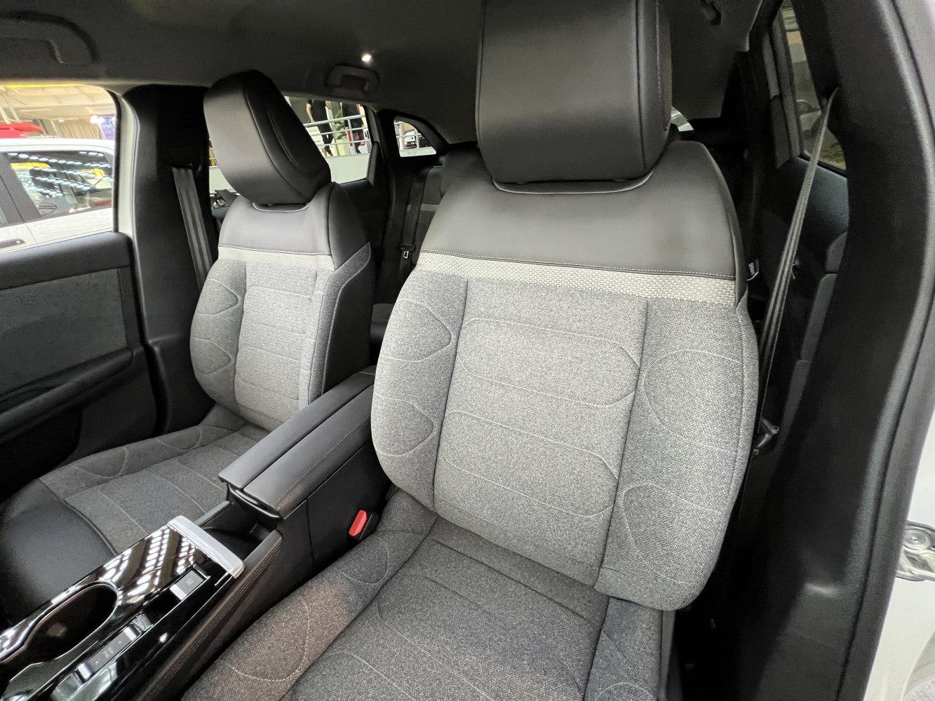 Front seats with grey fabric and black leather trim and sleek center console