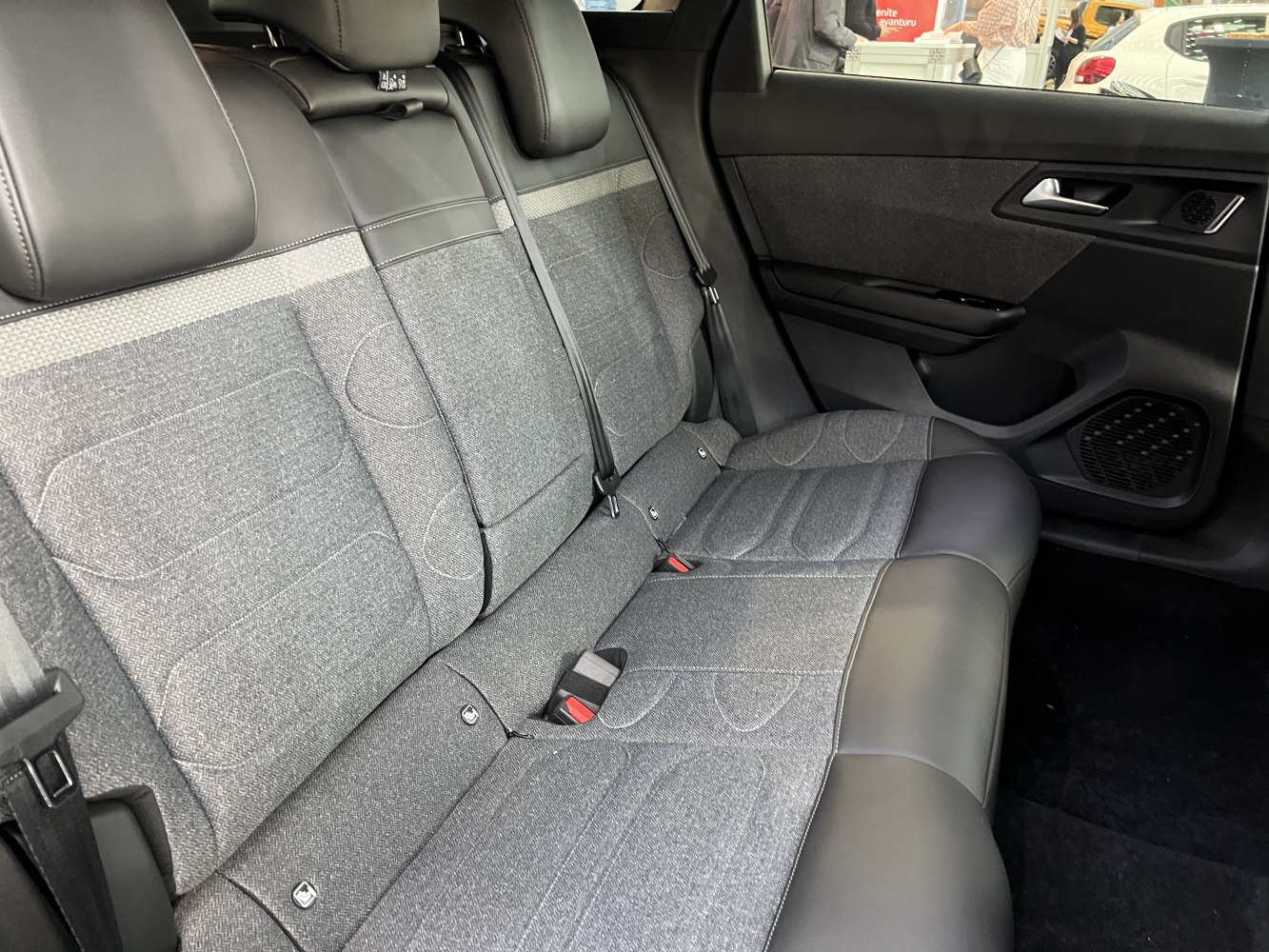 Fabric and leather rear seats with seat belts and side door panel