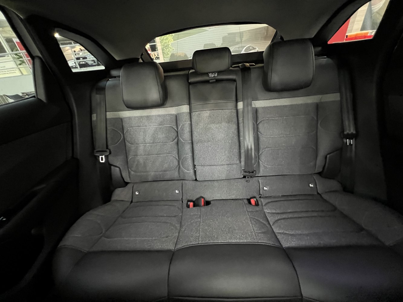 Rear seat interior with black upholstery and integrated headrests