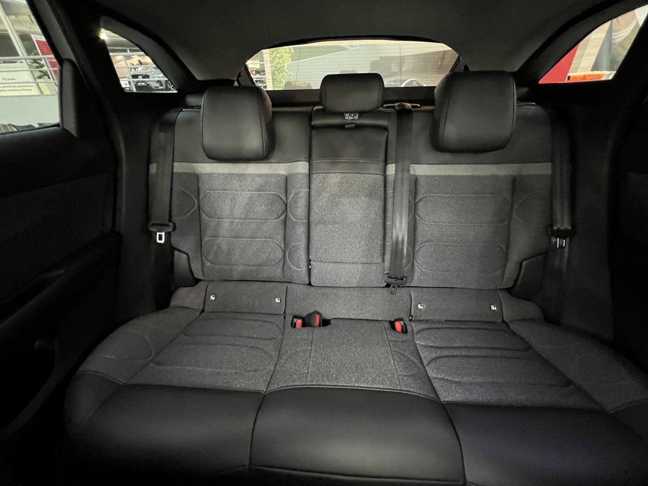 Rear seats with fabric and leather upholstery, headrests, and seatbelts