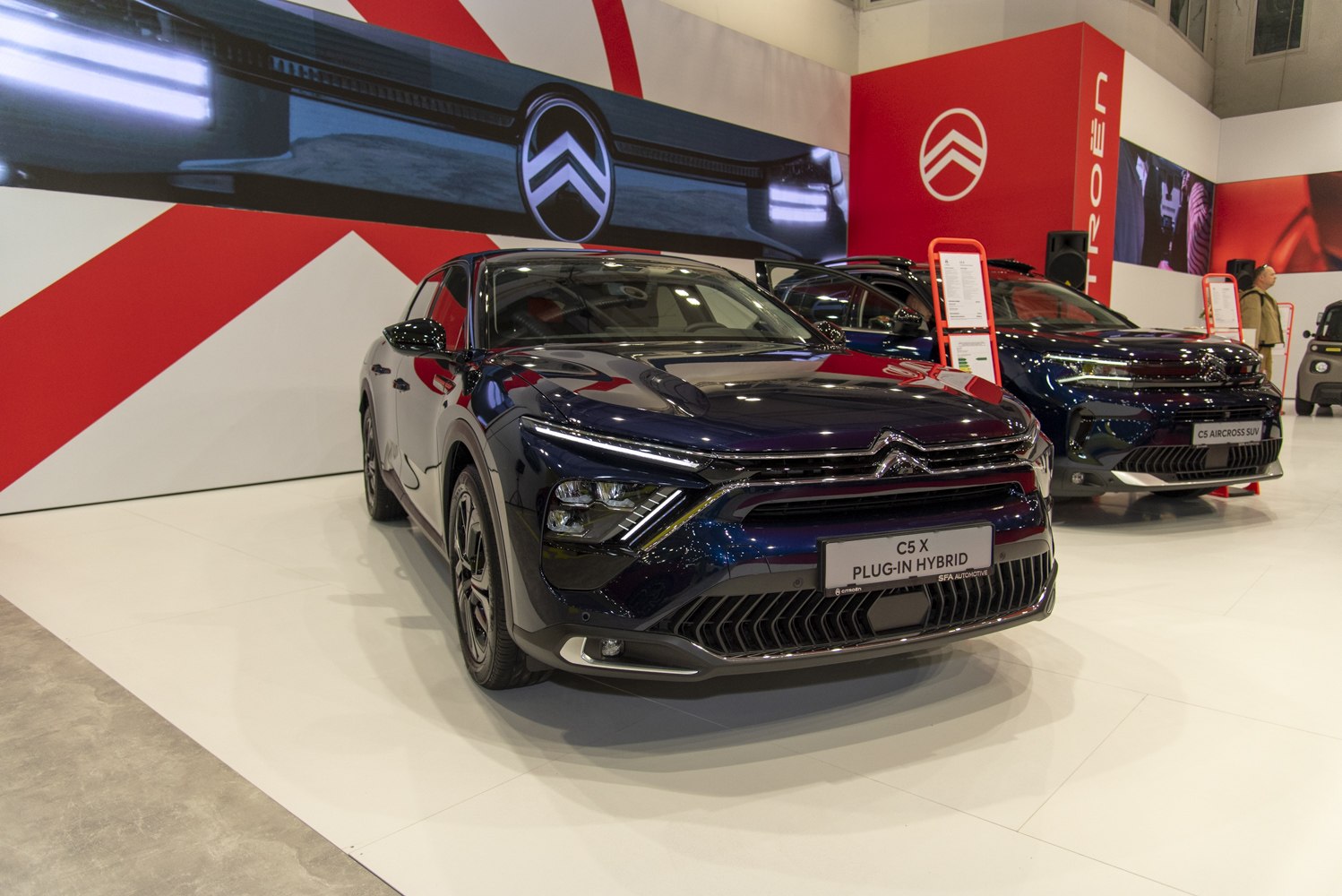 Front view with distinctive LED headlights and aerodynamic grille