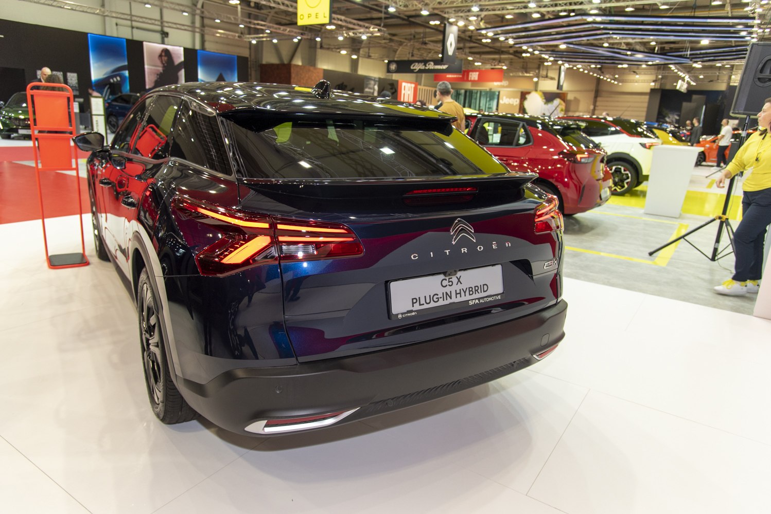 Rear view of plug-in hybrid with distinctive LED tail lights and aerodynamic design.