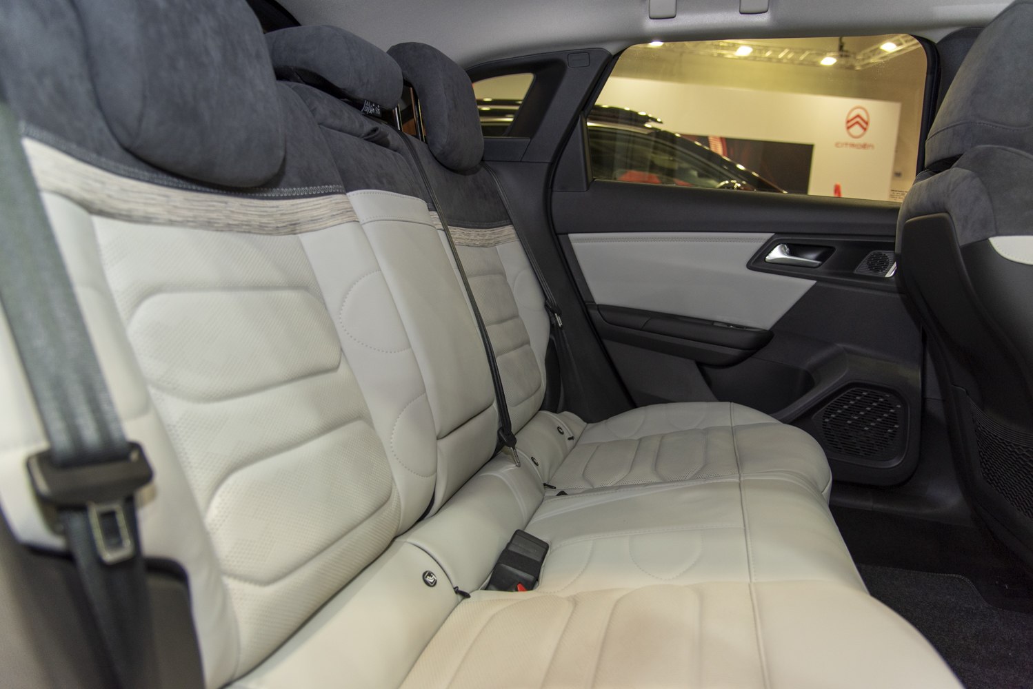 Rear seat leather upholstery with integrated headrests and door panel