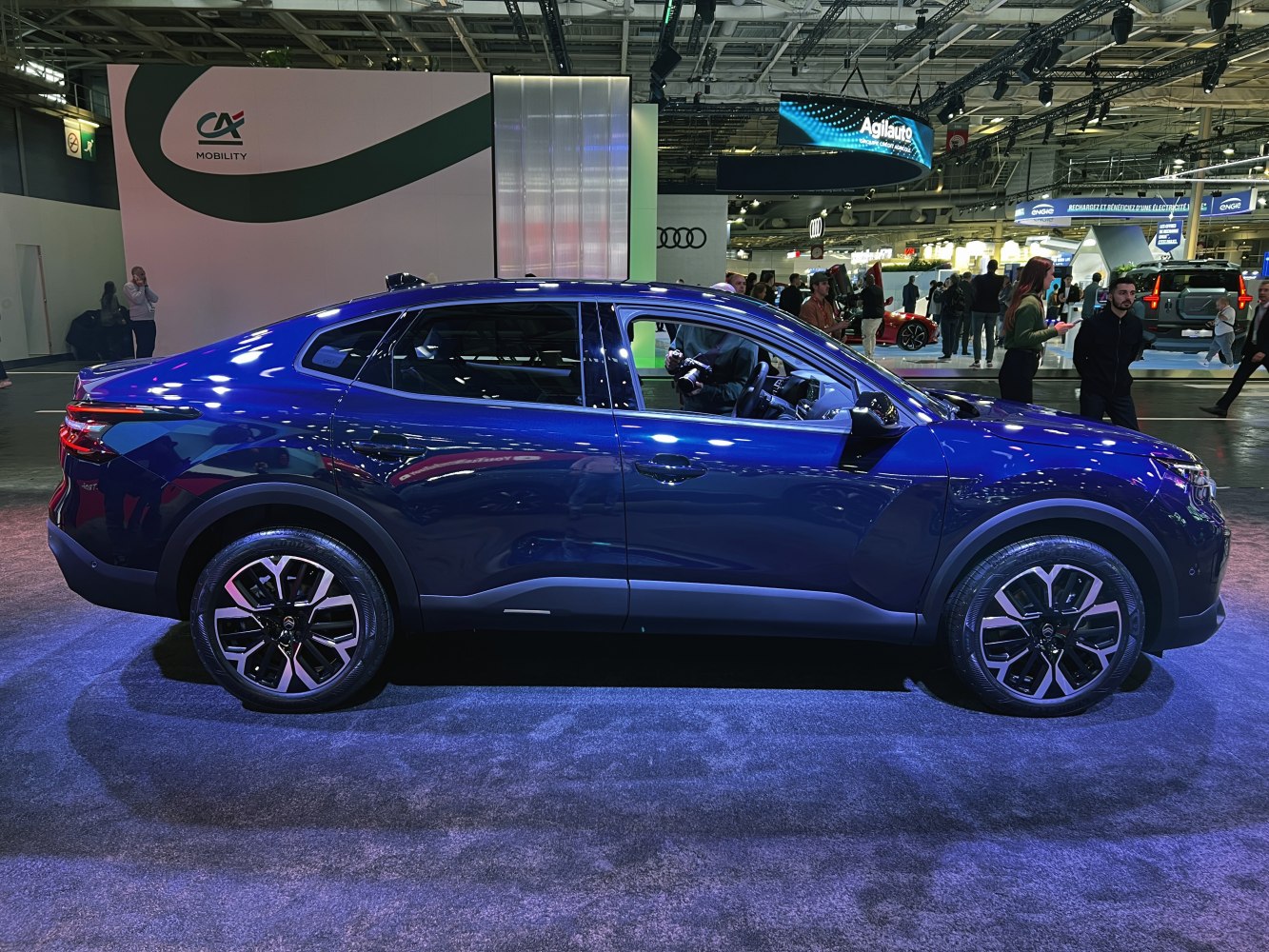 Modern sleek blue crossover SUV with alloy wheels