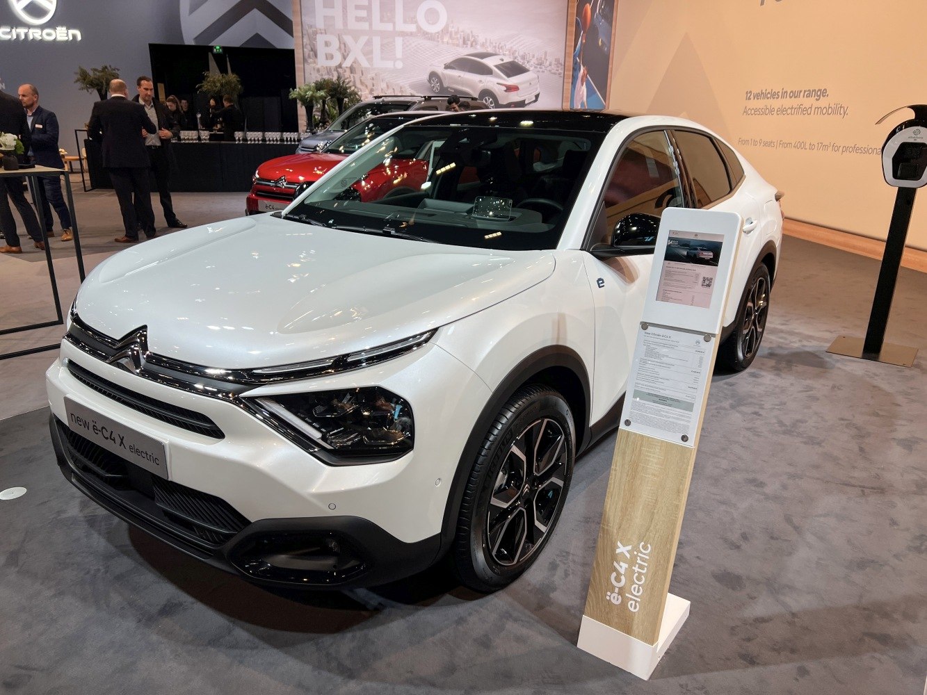 Front view of electric vehicle with LED headlights and black roof.