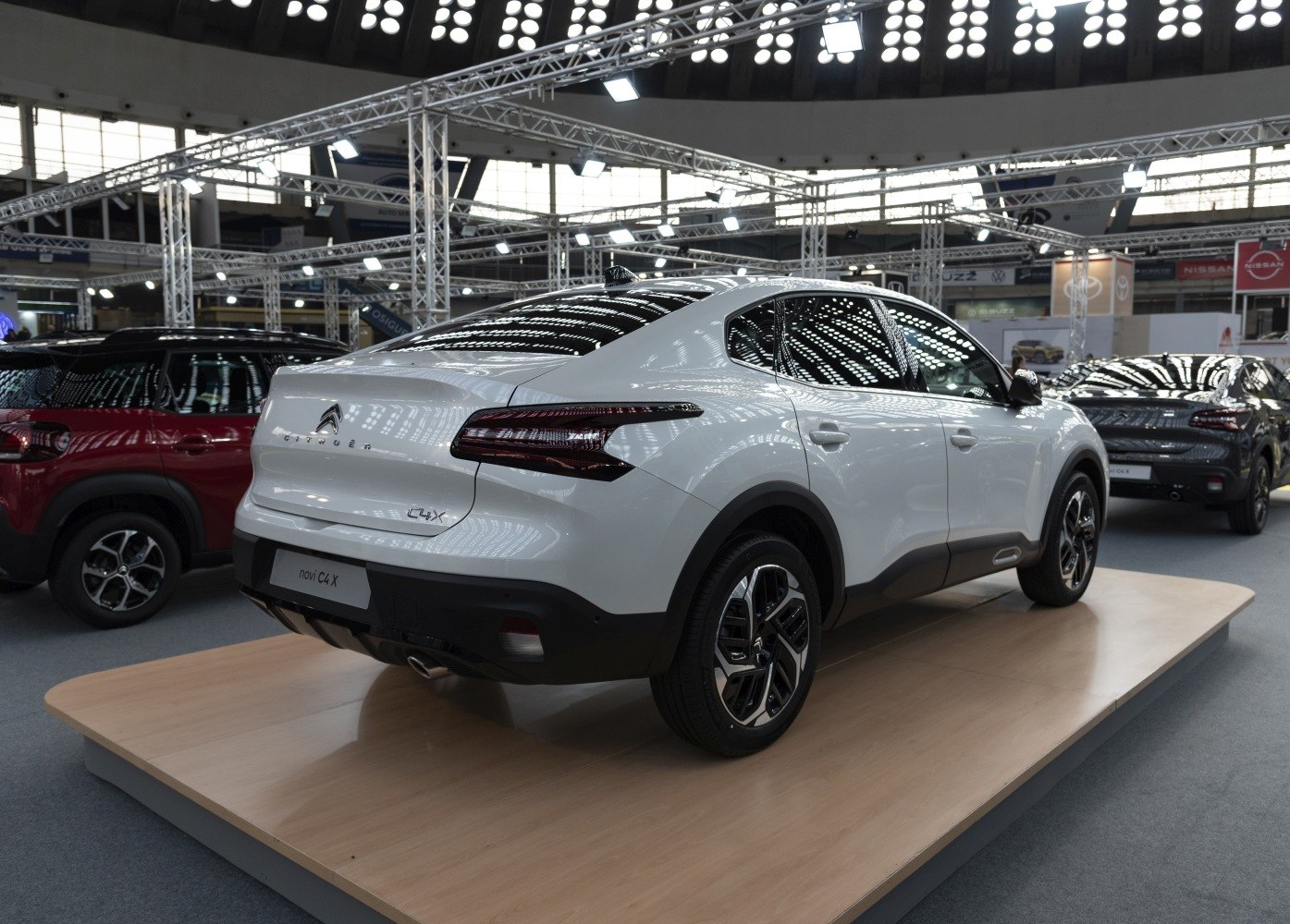 Rear and side view of modern white coupe SUV with distinctive tail lights and alloy wheels