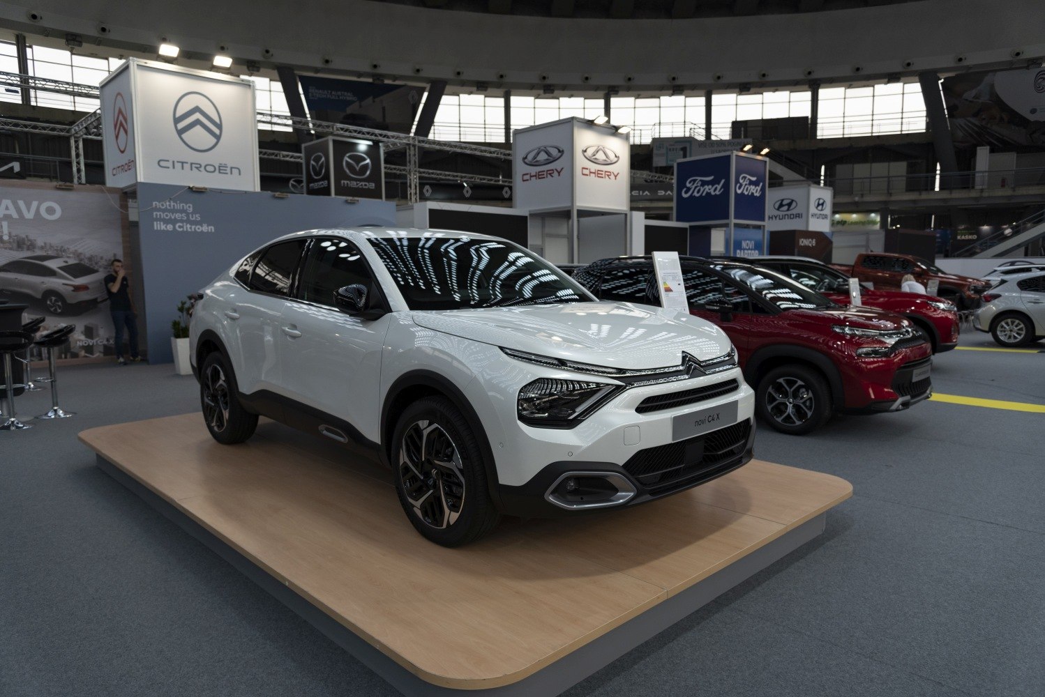 Sleek white vehicle with distinctive front lights and aerodynamic body