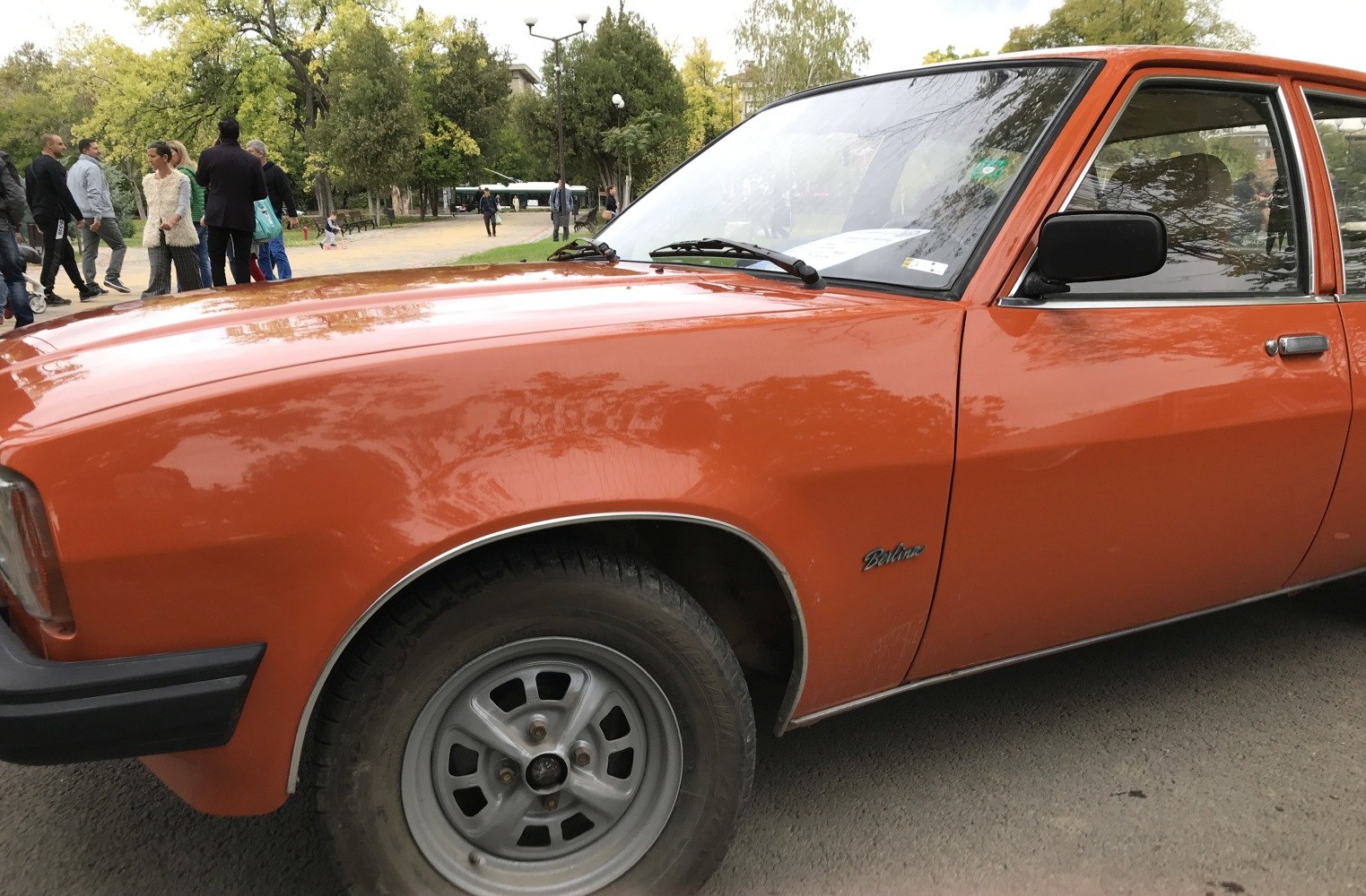 Orange front side with wheel and side mirror of vintage sedan