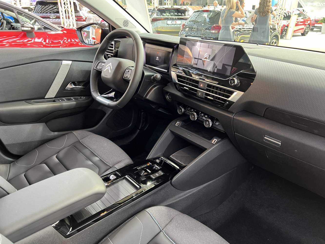 Digital dashboard and touchscreen infotainment with ergonomic steering and climate controls.