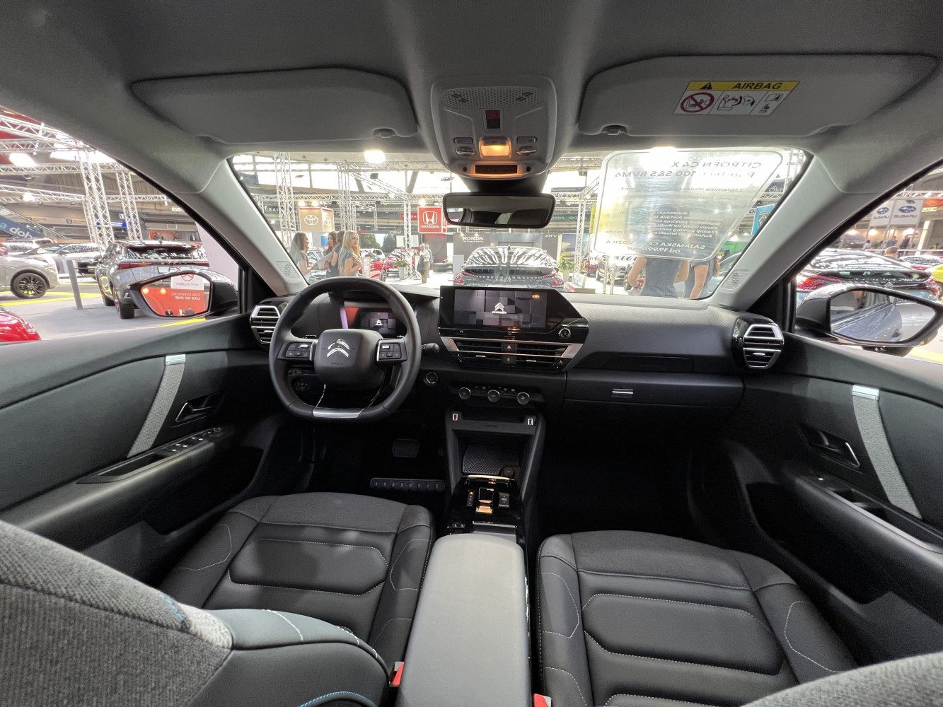 Modern black dashboard and steering wheel with digital display and ergonomic seats