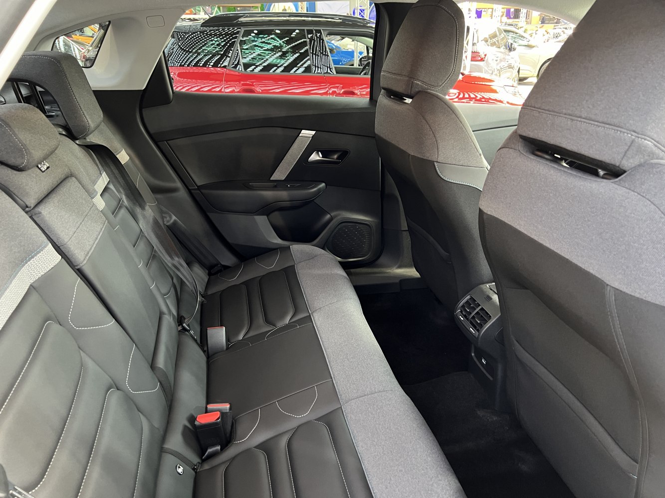 Rear seat interior with modern upholstery and rear air vents.