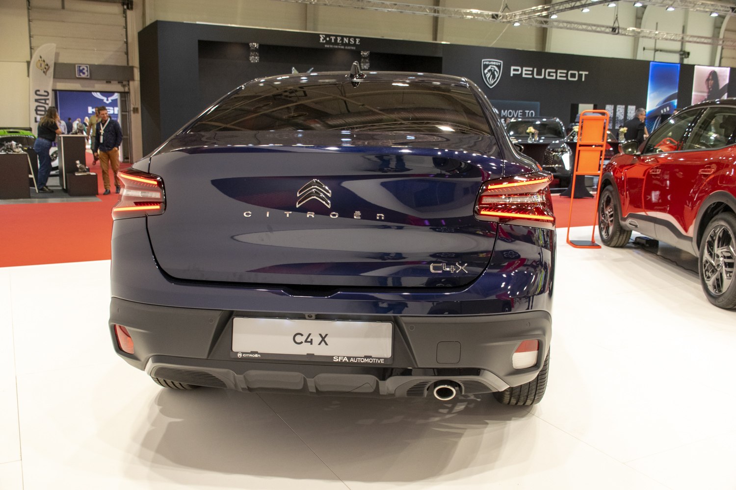 Rear view with distinctive tail lights and exhaust