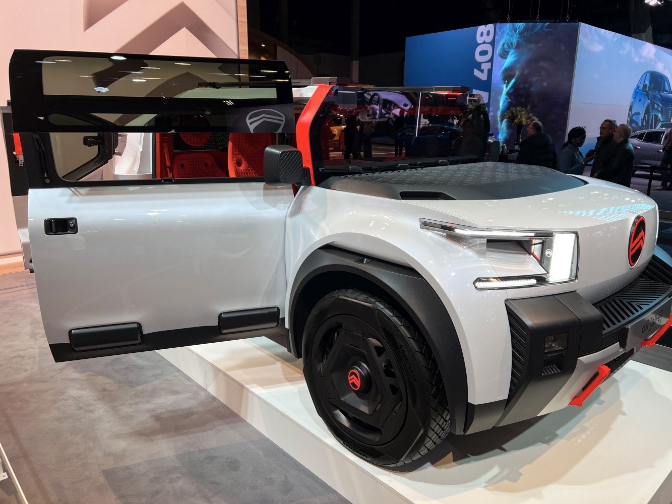 Futuristic SUV with LED headlights and open front door.