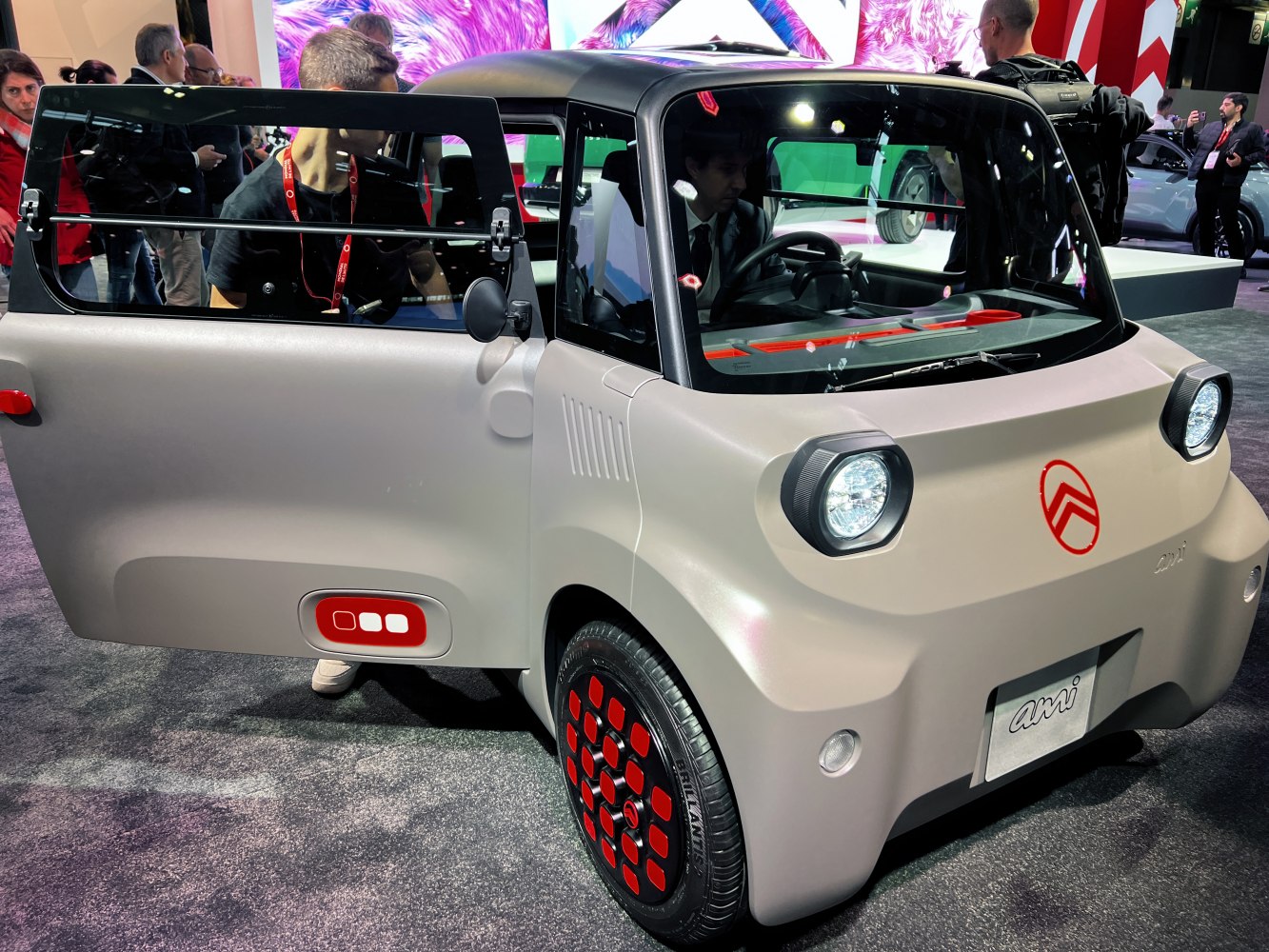 Front headlights and side-opening door with red-accented wheels