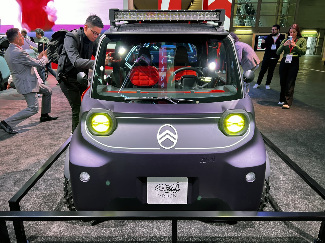 Compact electric buggy with yellow headlights and roof light bar