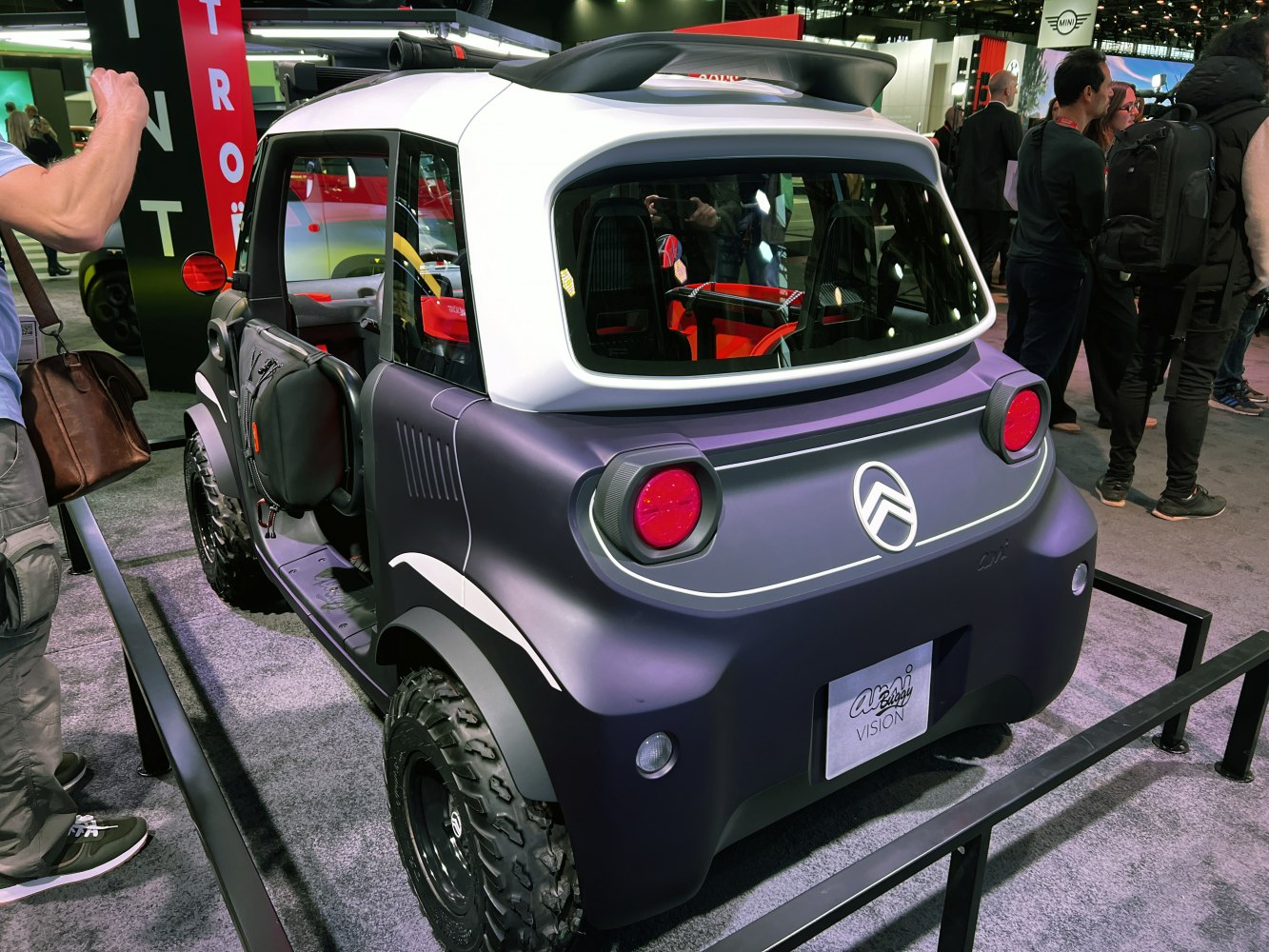 Rear view of compact electric buggy with off-road tires and unique rear design