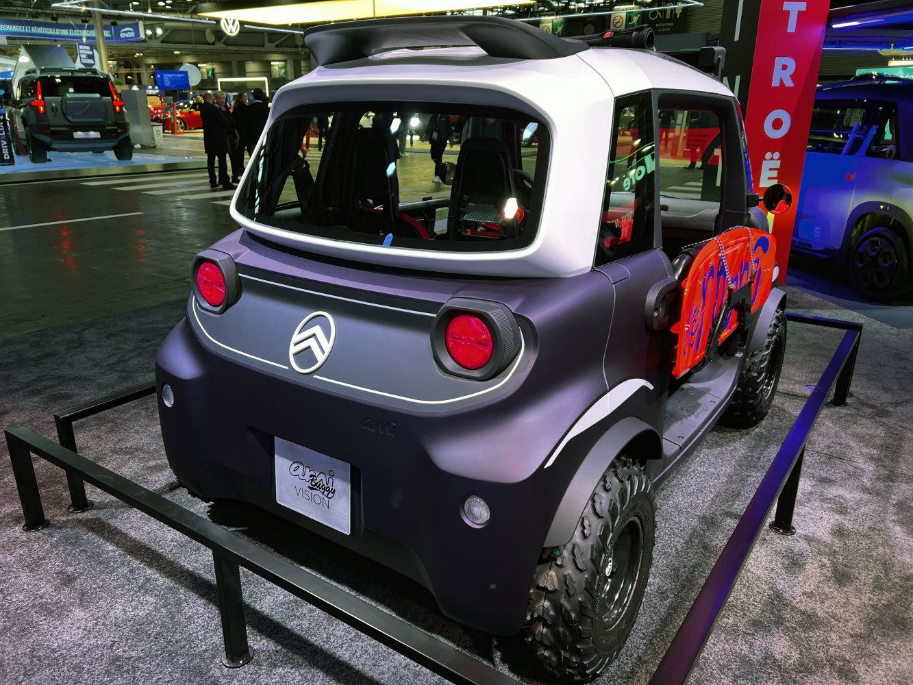 Rear view of electric buggy with off-road tires and compact design