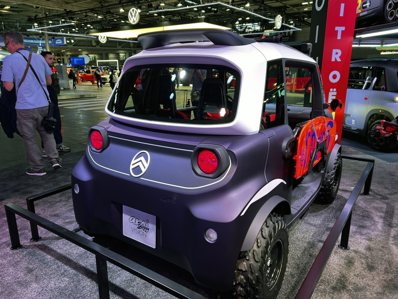 Rear view of electric buggy with off-road tires and open side design