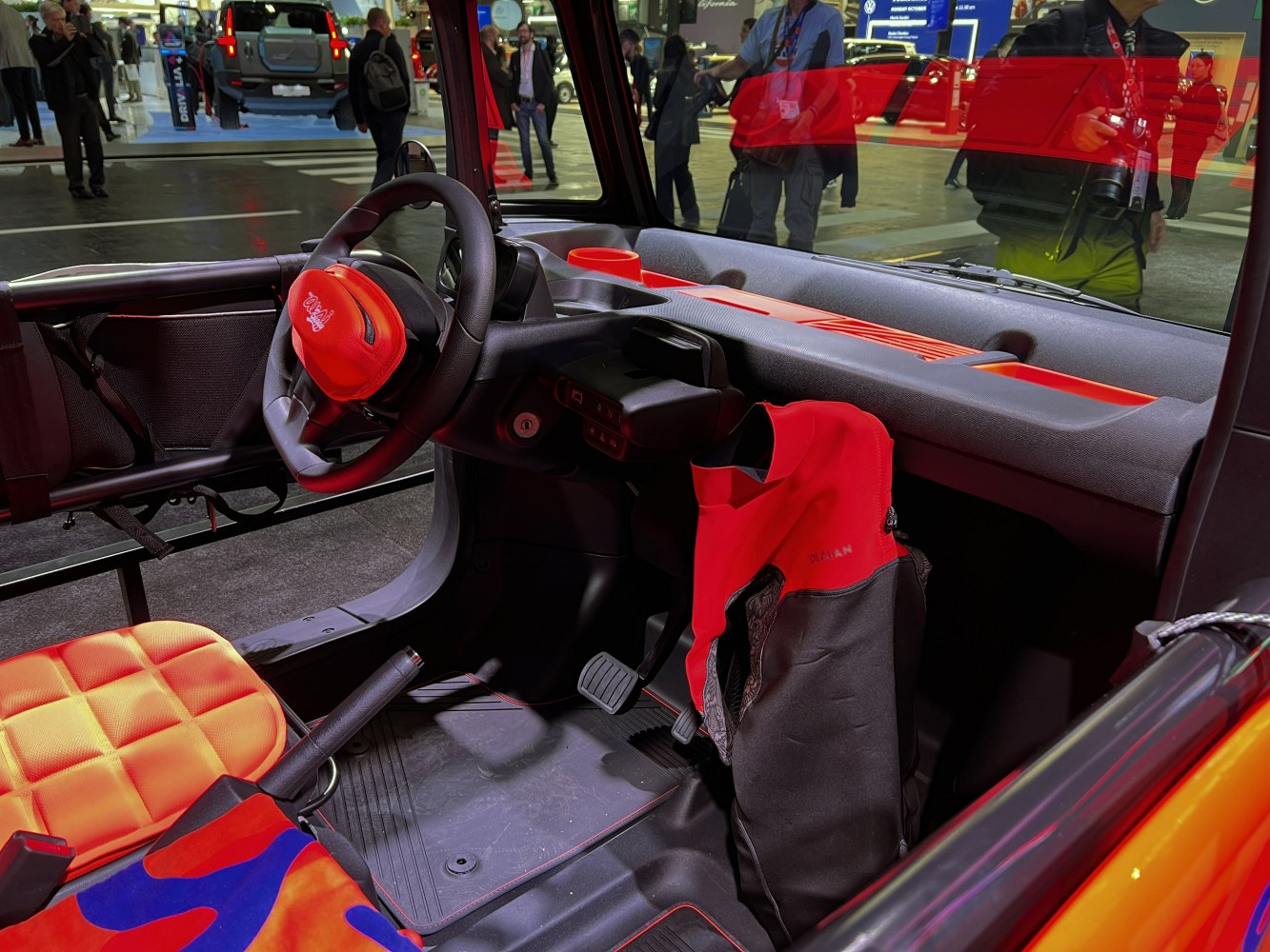 Compact electric buggy dashboard and orange quilted seat interior