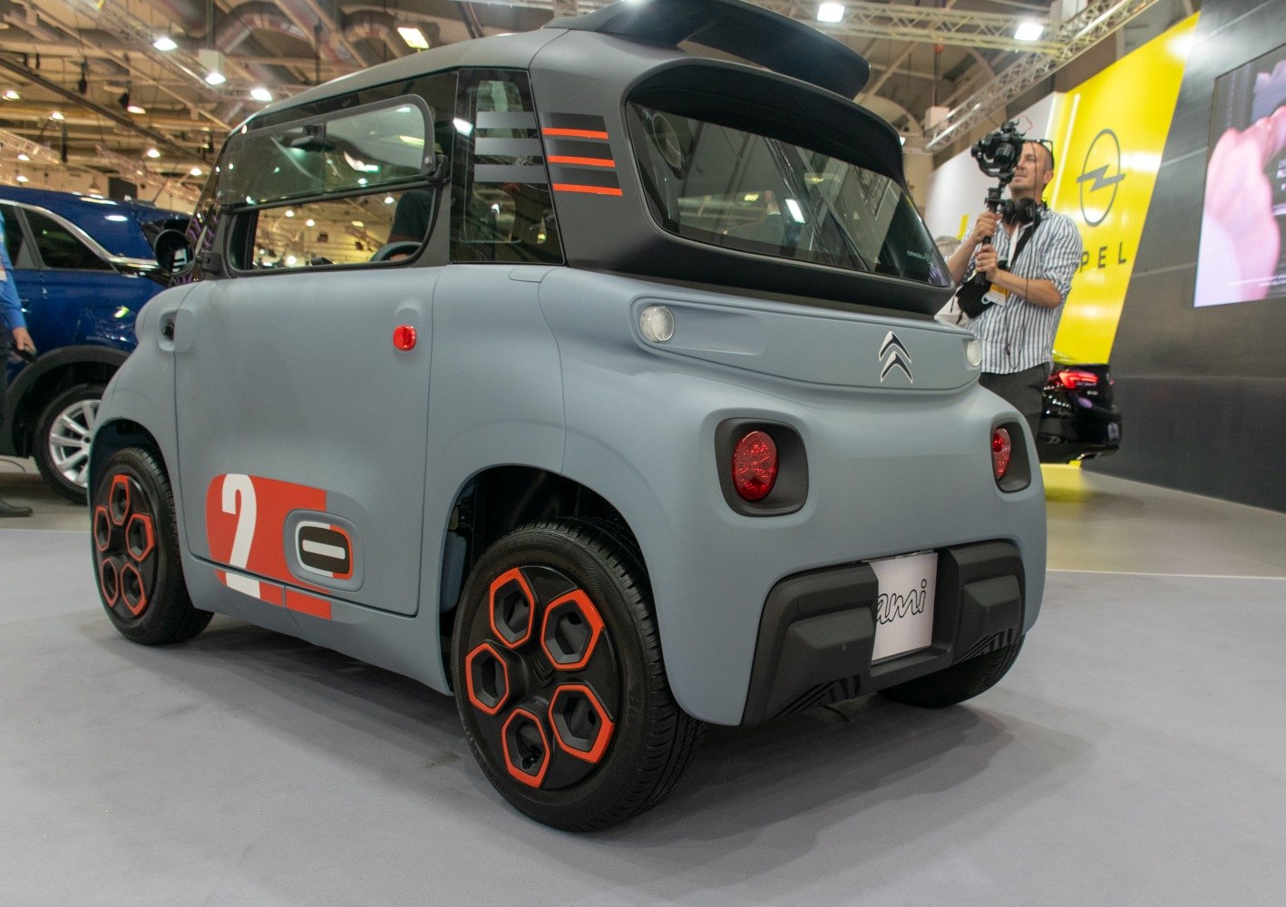 Rear and side view of compact EV with sporty hexagonal wheels and matte finish