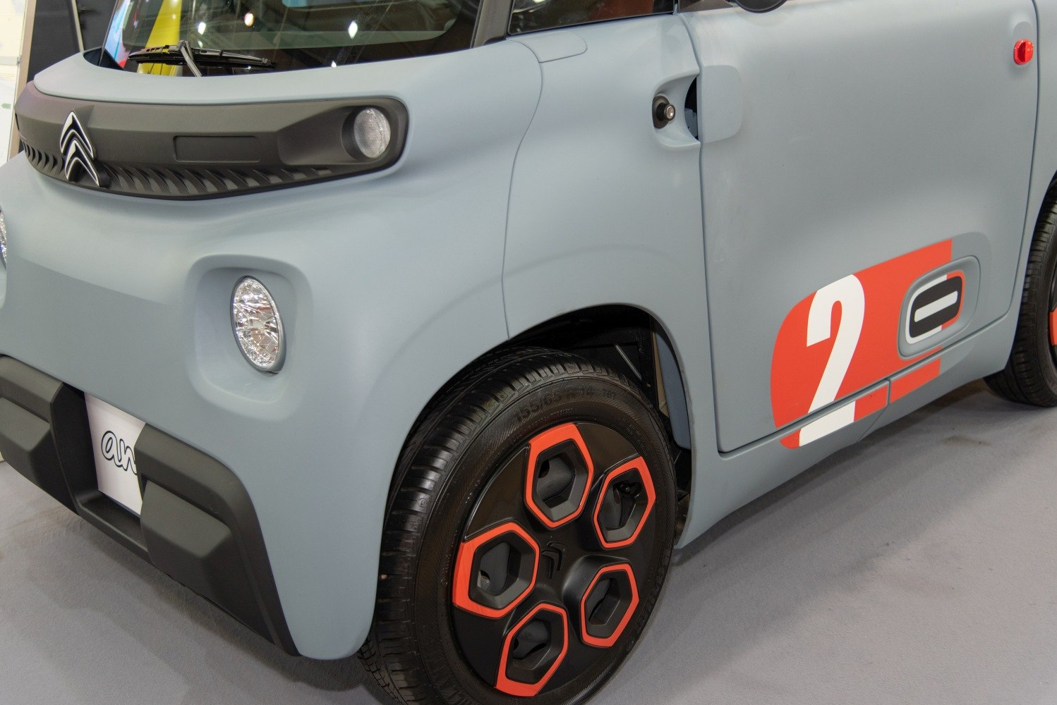 Front close-up with unique headlights and colorful five-hole alloy wheel design