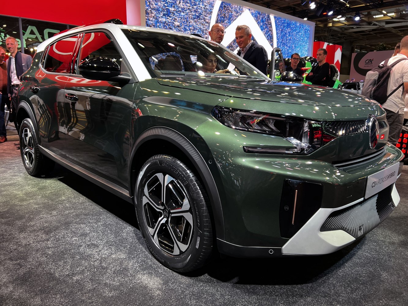 Sharp LED headlights and two-tone roof on dark green modern SUV