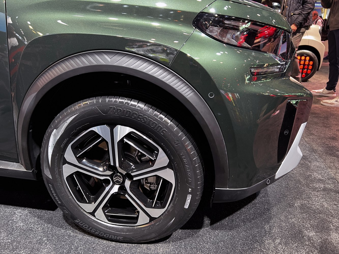 Rear alloy wheel and tail light design with Bridgestone tire on green body
