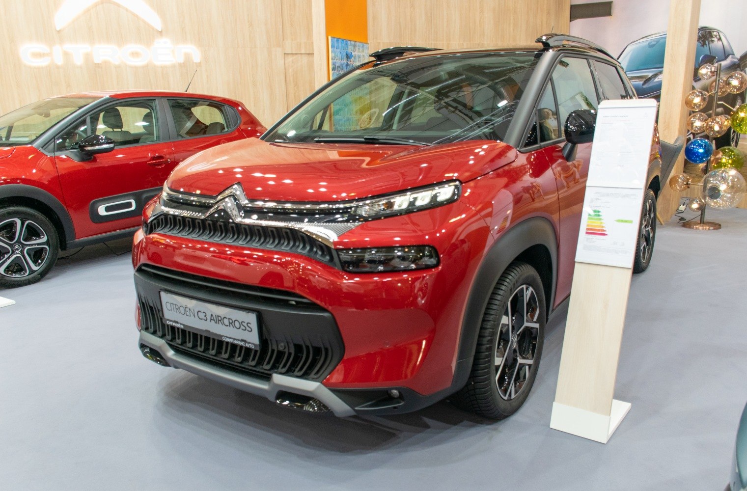 Front view with black grille and LED headlights of red compact SUV