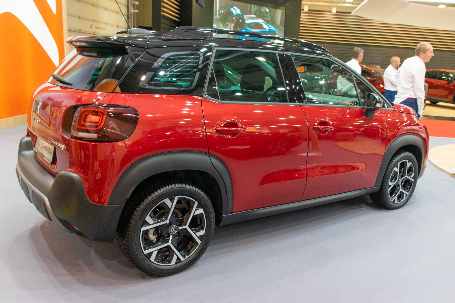 Rear side view with distinctive taillights and two-tone roof.