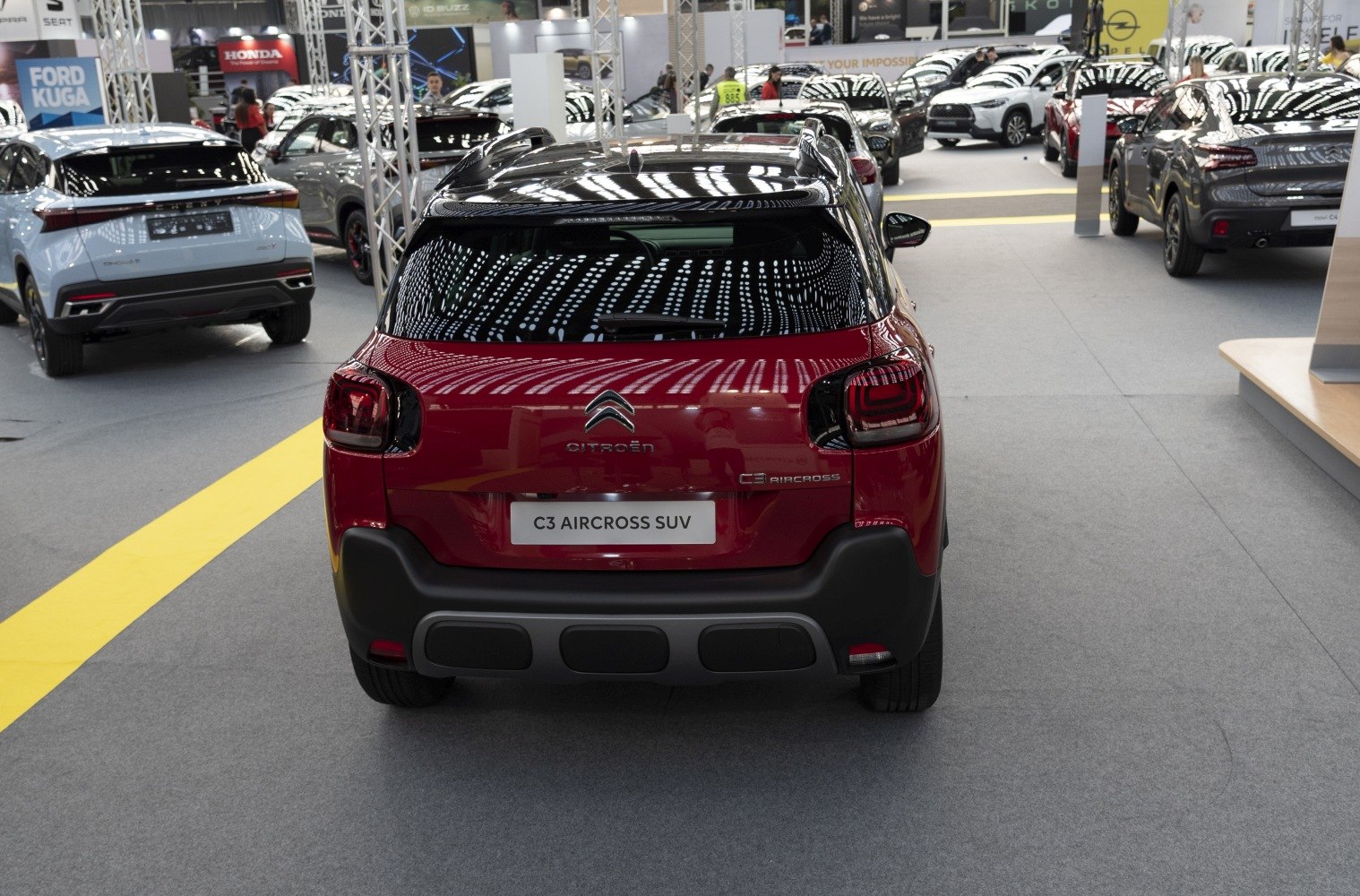 Rear view showing taillights and design of a compact SUV with black roof