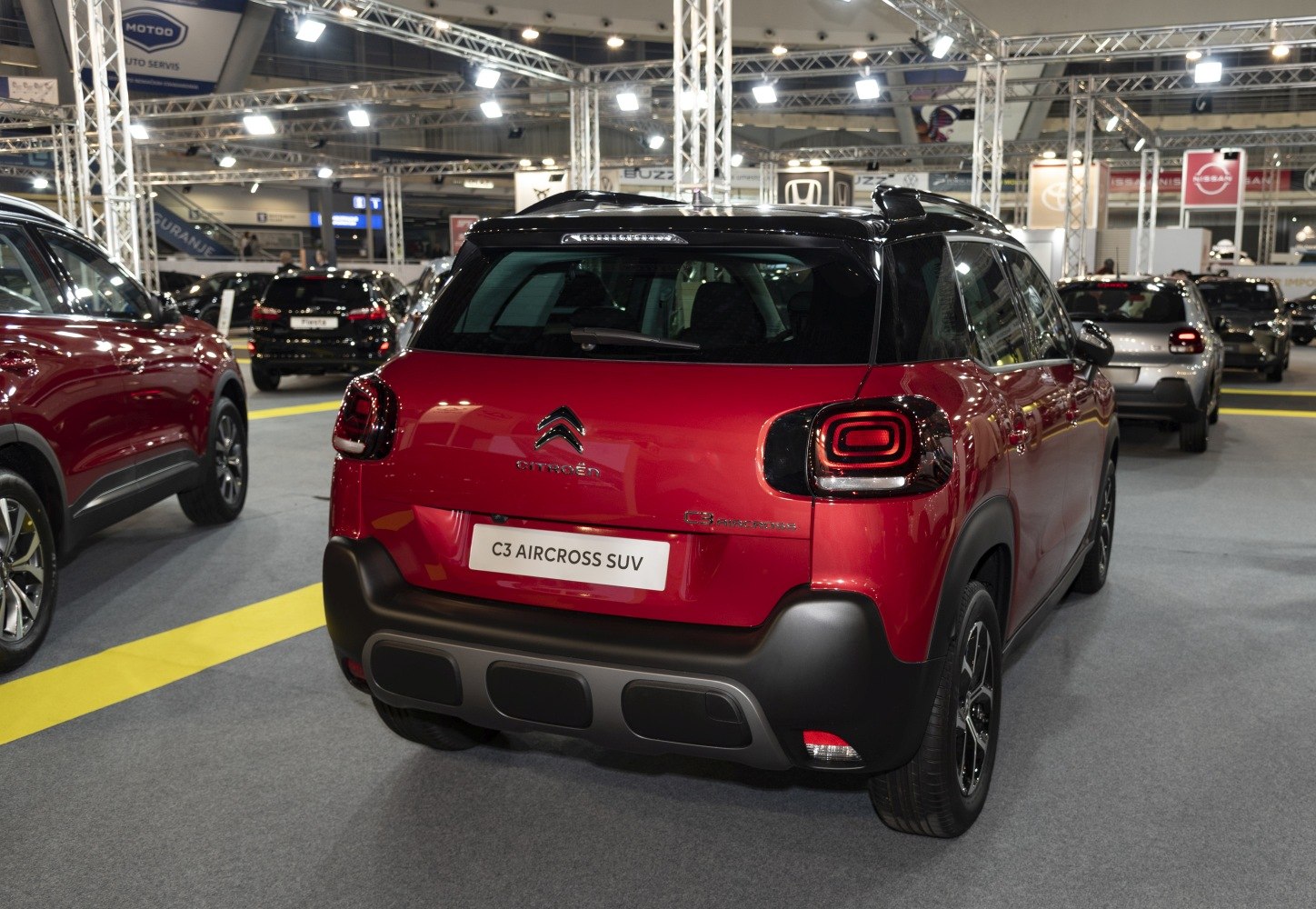 Rear view of red SUV with distinctive taillights and black roof